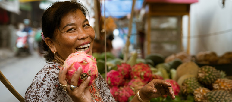 Woman holding dragon fruit