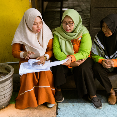 three womens reading a folder together