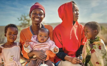 Two-mothers-with-their-children-one-smiling-to-the-camera-and-the-other-one-looking-away