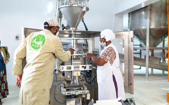 Two workers fortifying flour in Kenya