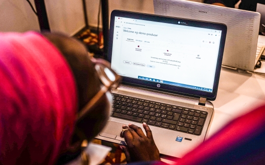 A lady from Nigeria reviewing data on the status of food fortification in the country. A lady from Nigeria reviewing data on the status of food fortification in the country.