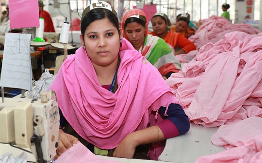 Garment worker with pink headscarf