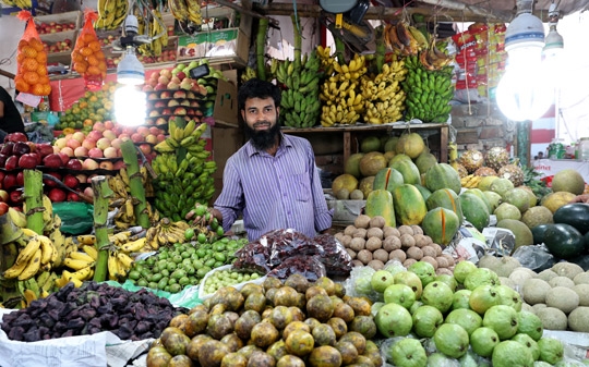 Man selling vegetables in a market in Bangladesh