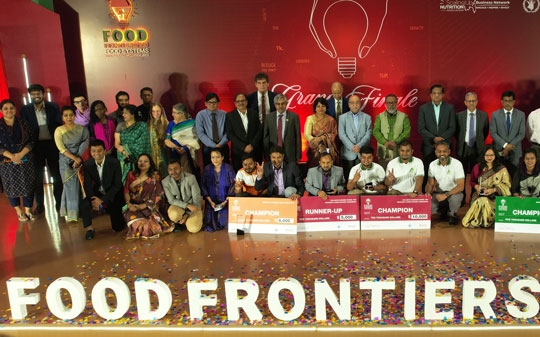 The winners of the food frontiers event lined up on stage with prizes
