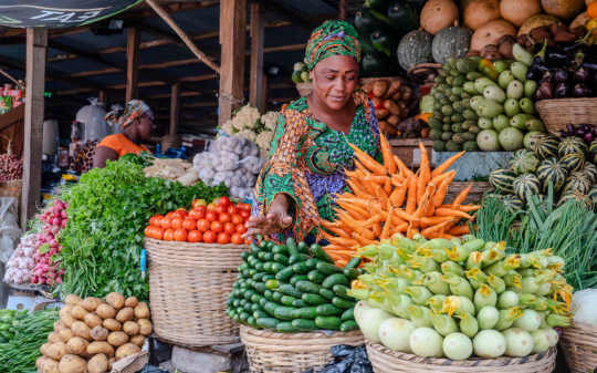 A female vendor at her vegetable stall