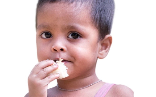 A young child eating fruit