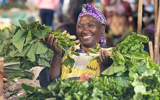 a woman vendor with some lettuce