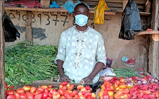 Produce Vendor with Mask on at Bernin Kebbi Market, Kebbi, Nigeria