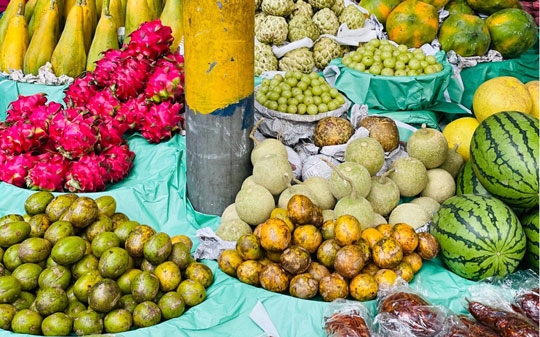 Market with passion fruits, dragon fruits, pears and watermelon