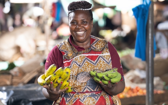 Vendor displaying bananas at her stall